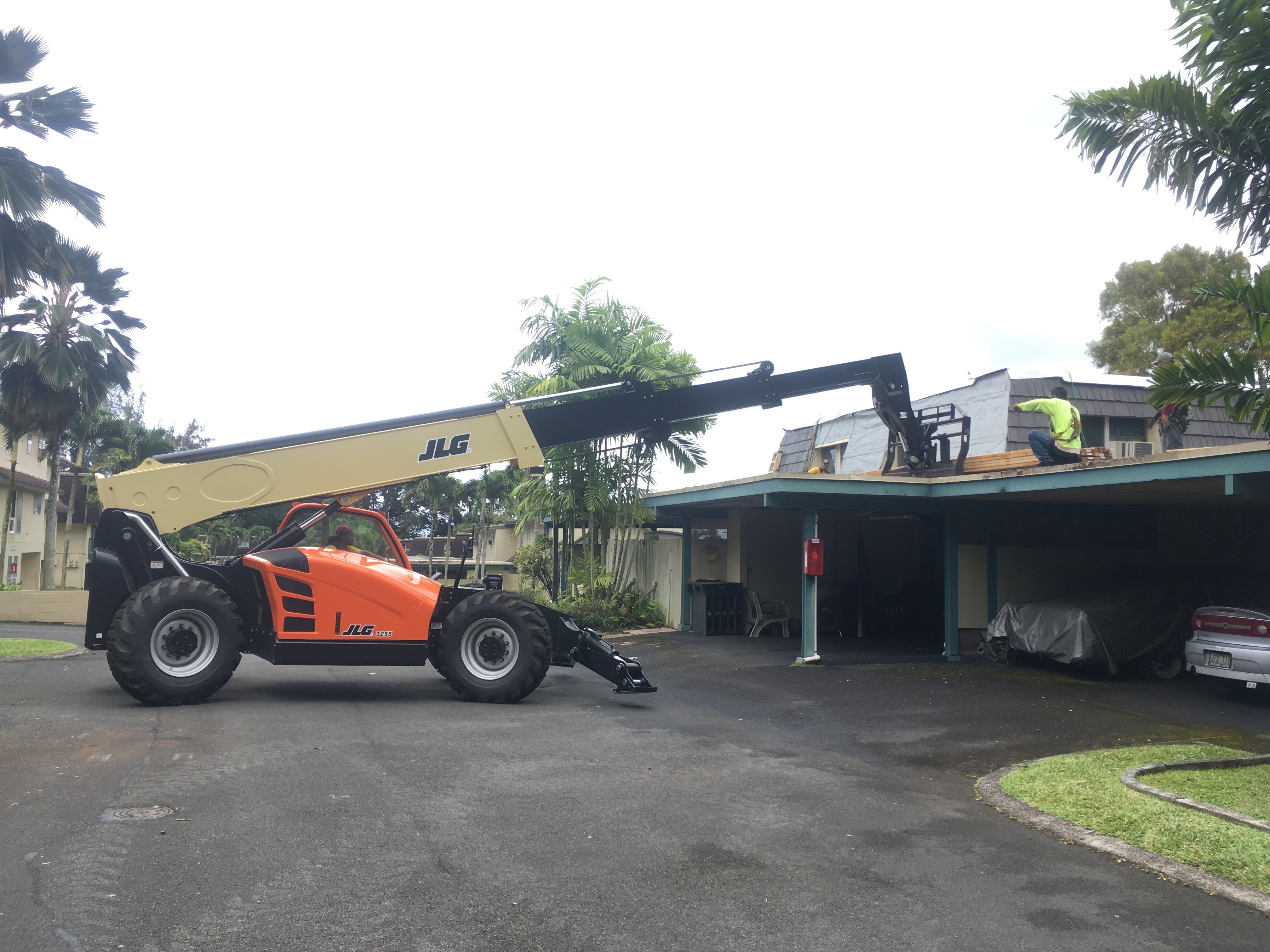Roofing job site with telehandler
